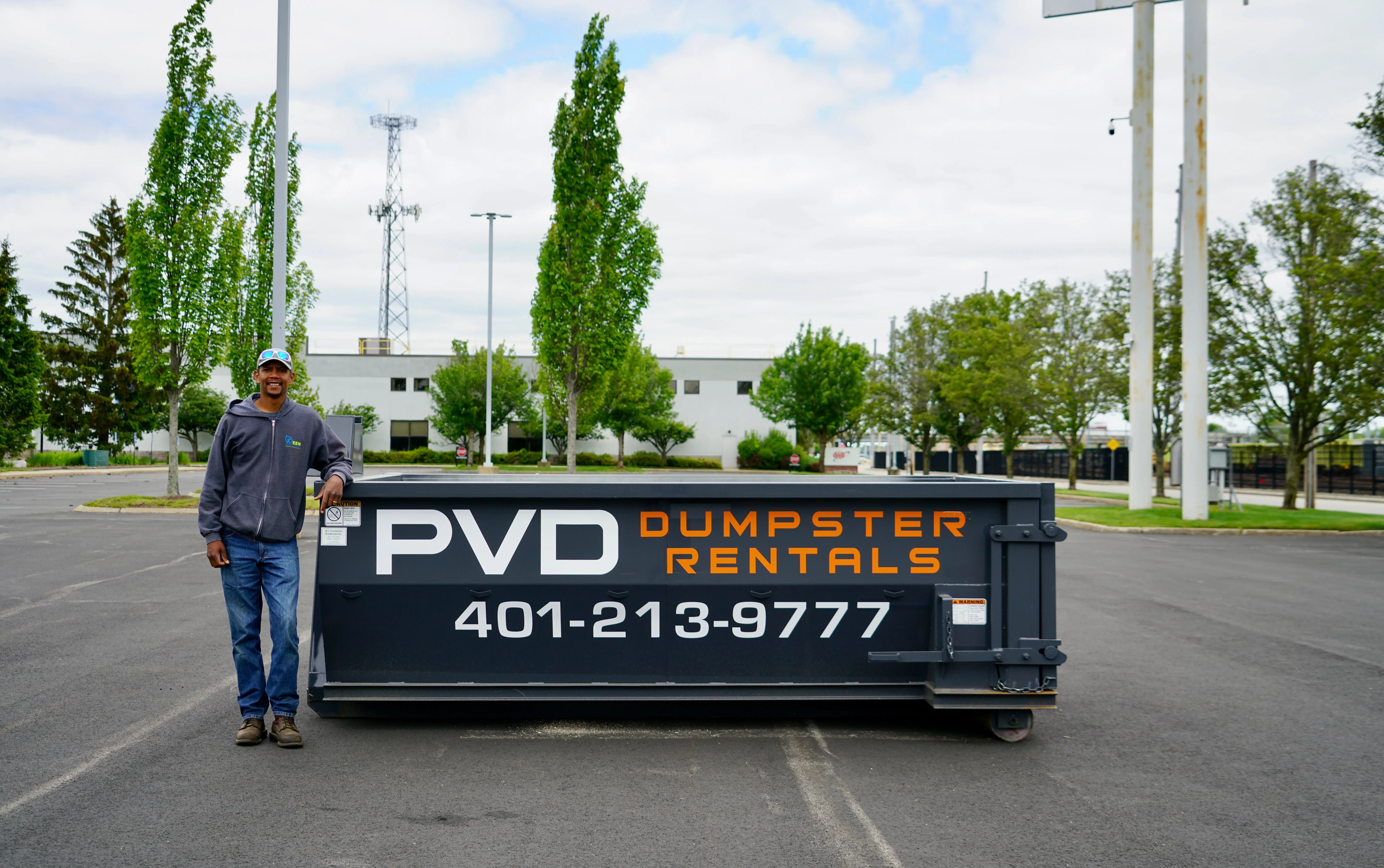 Jamaal Hazard, owner of PVD Dumpster Rentals, beside a 10 yard container