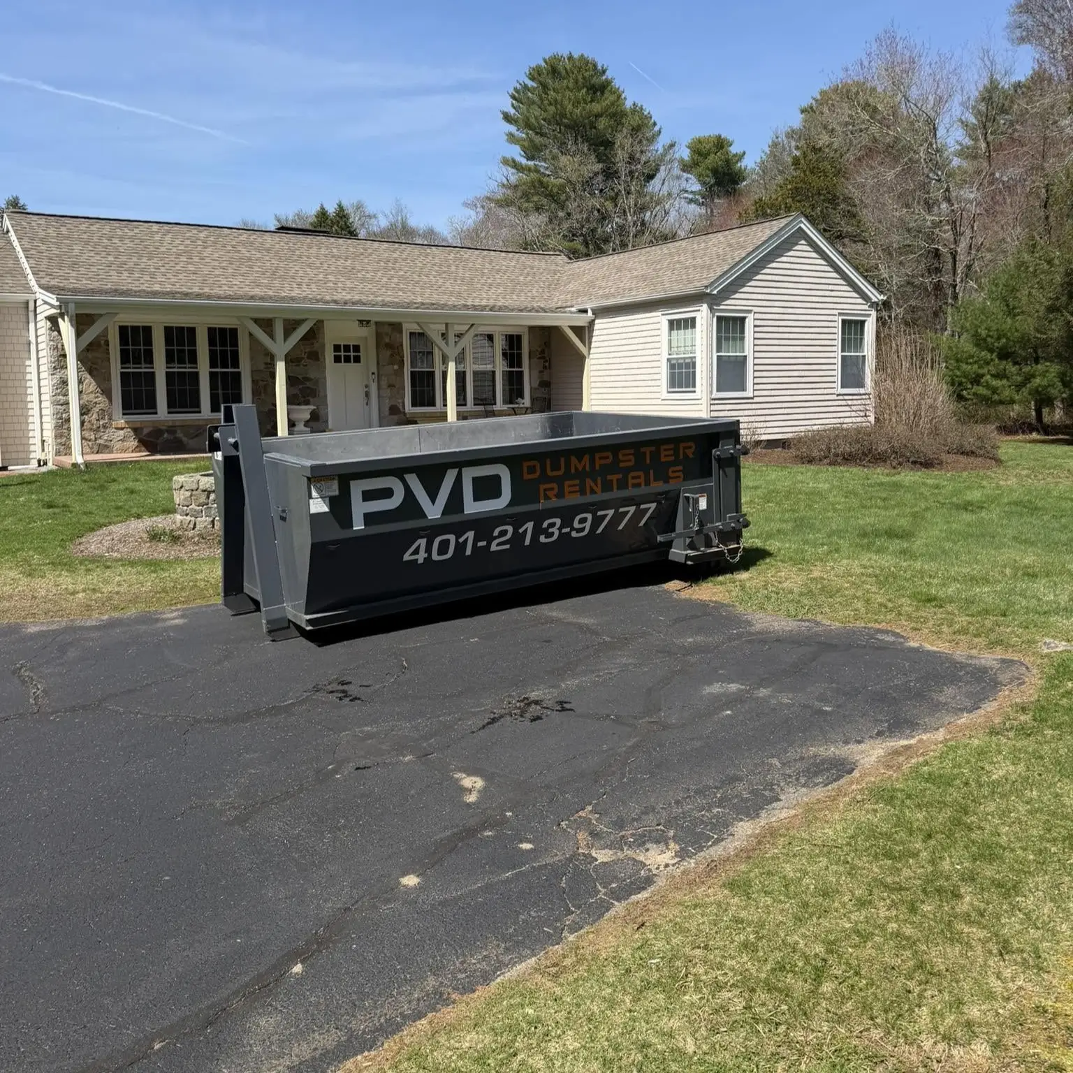 10 yard dumpster delivered to the driveway of a ranch home