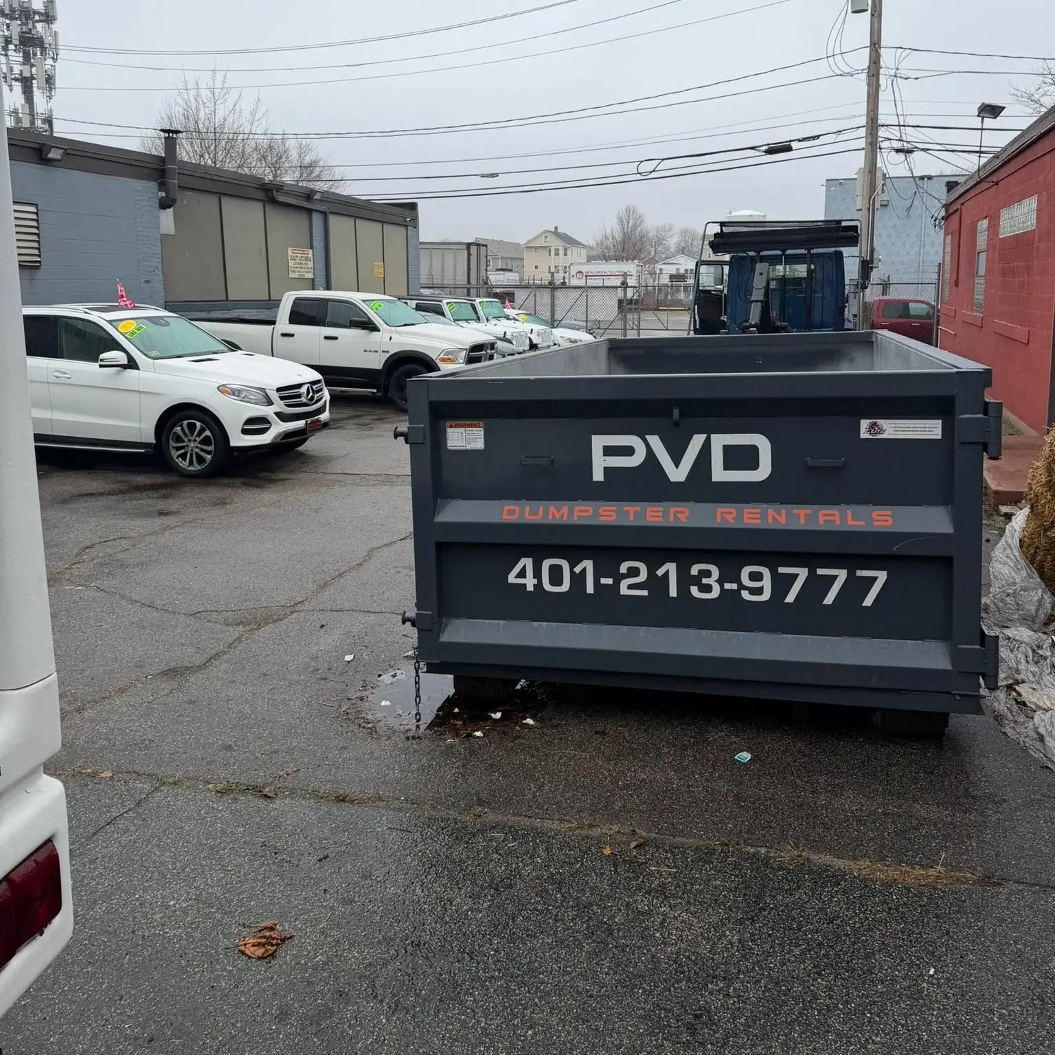 Rear view of a 10 yard roll-off dumpster being dropped off