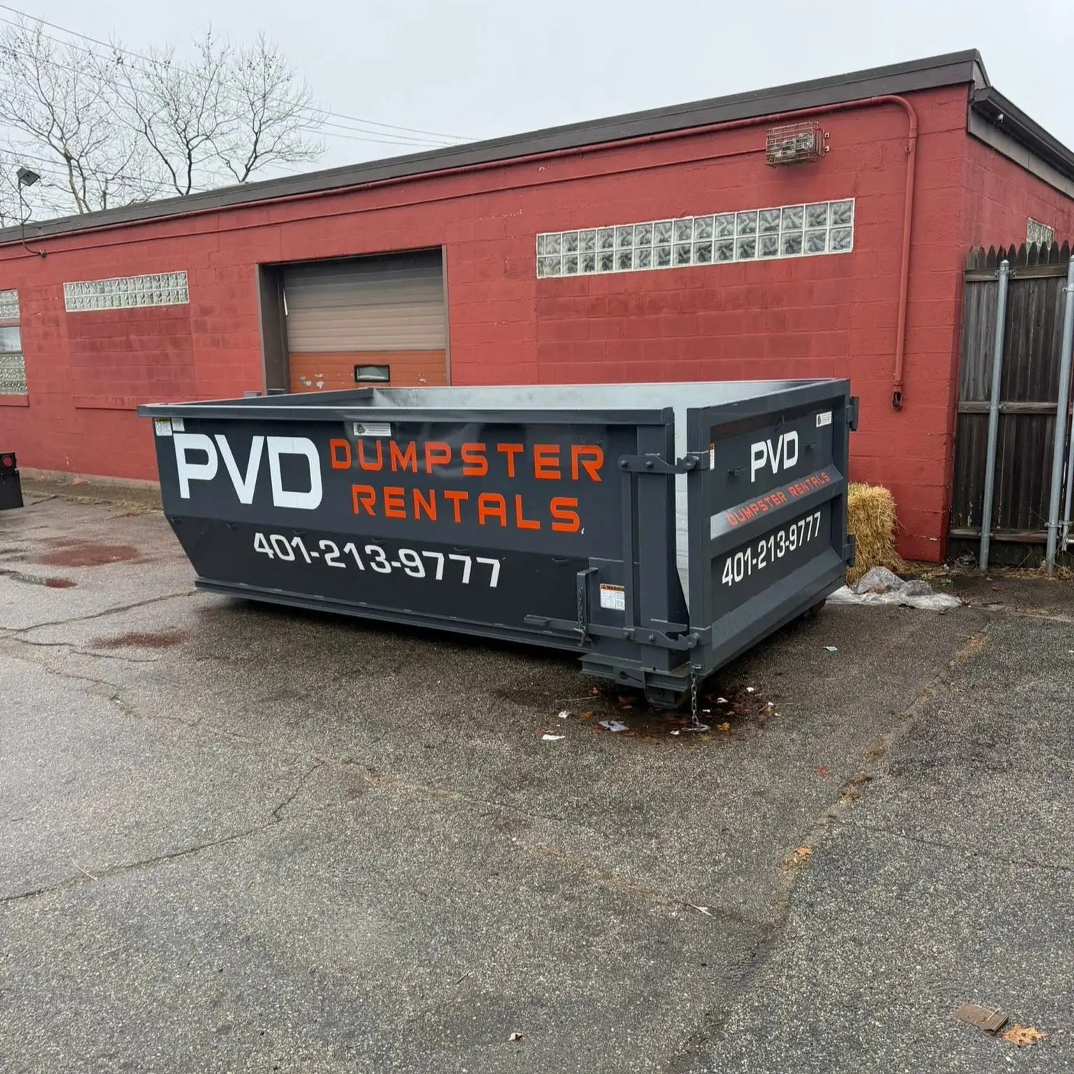 15 yard dumpster outside a warehouse on a commercial cleanout job in Cranston