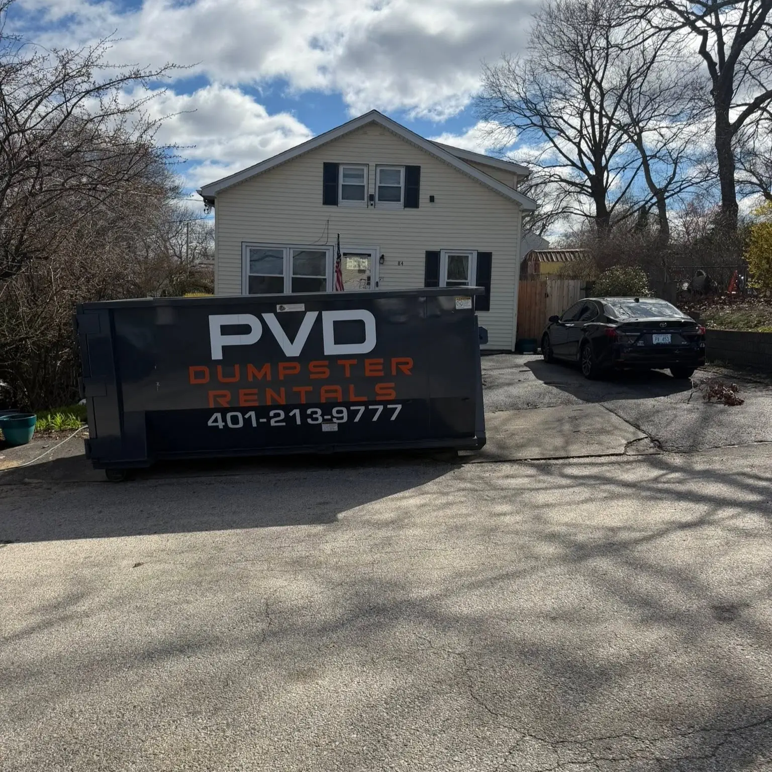 20 yard dumpster on the driveway of a two story home