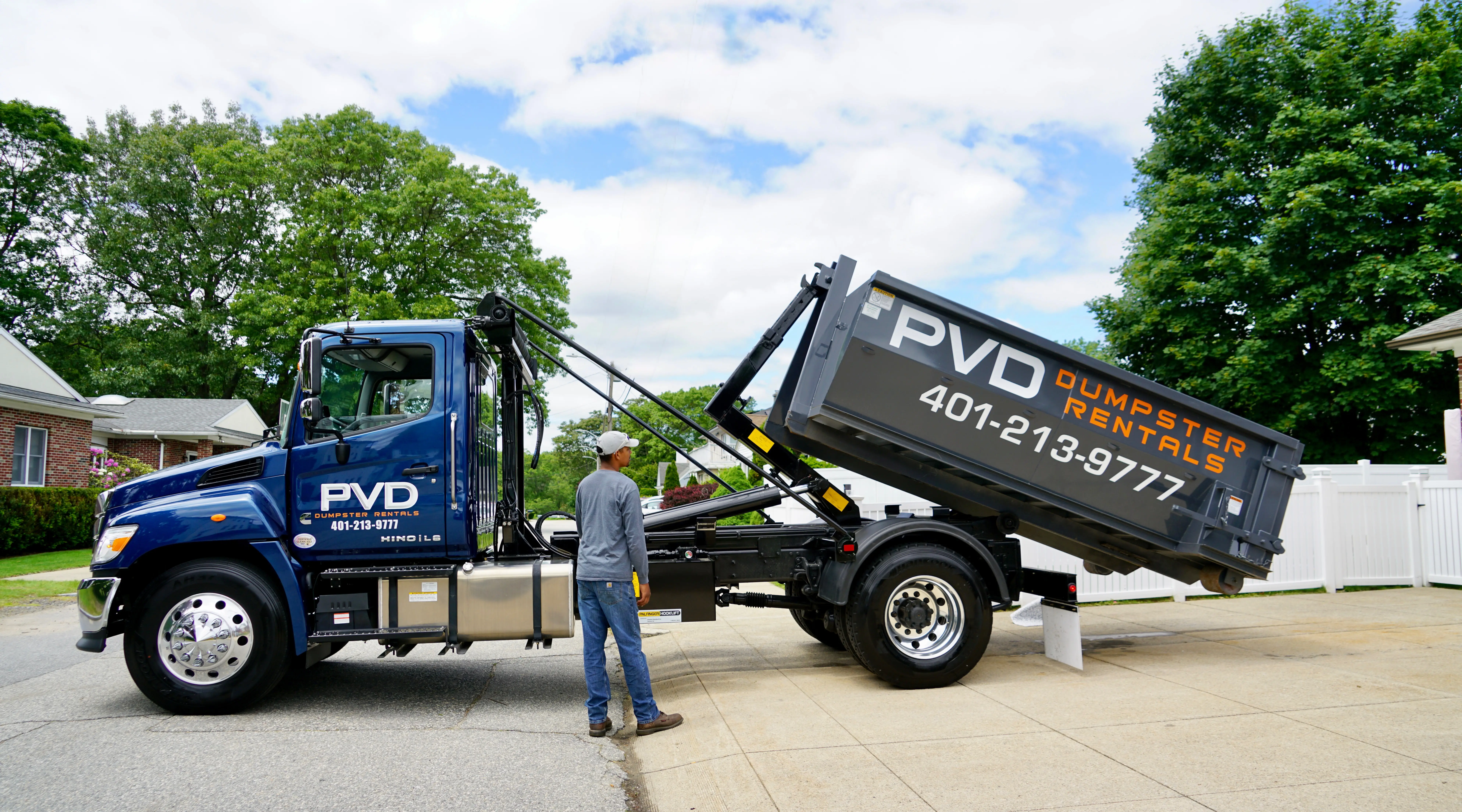 PVD Dumpster Rentals driver operating the truck controls during a delivery