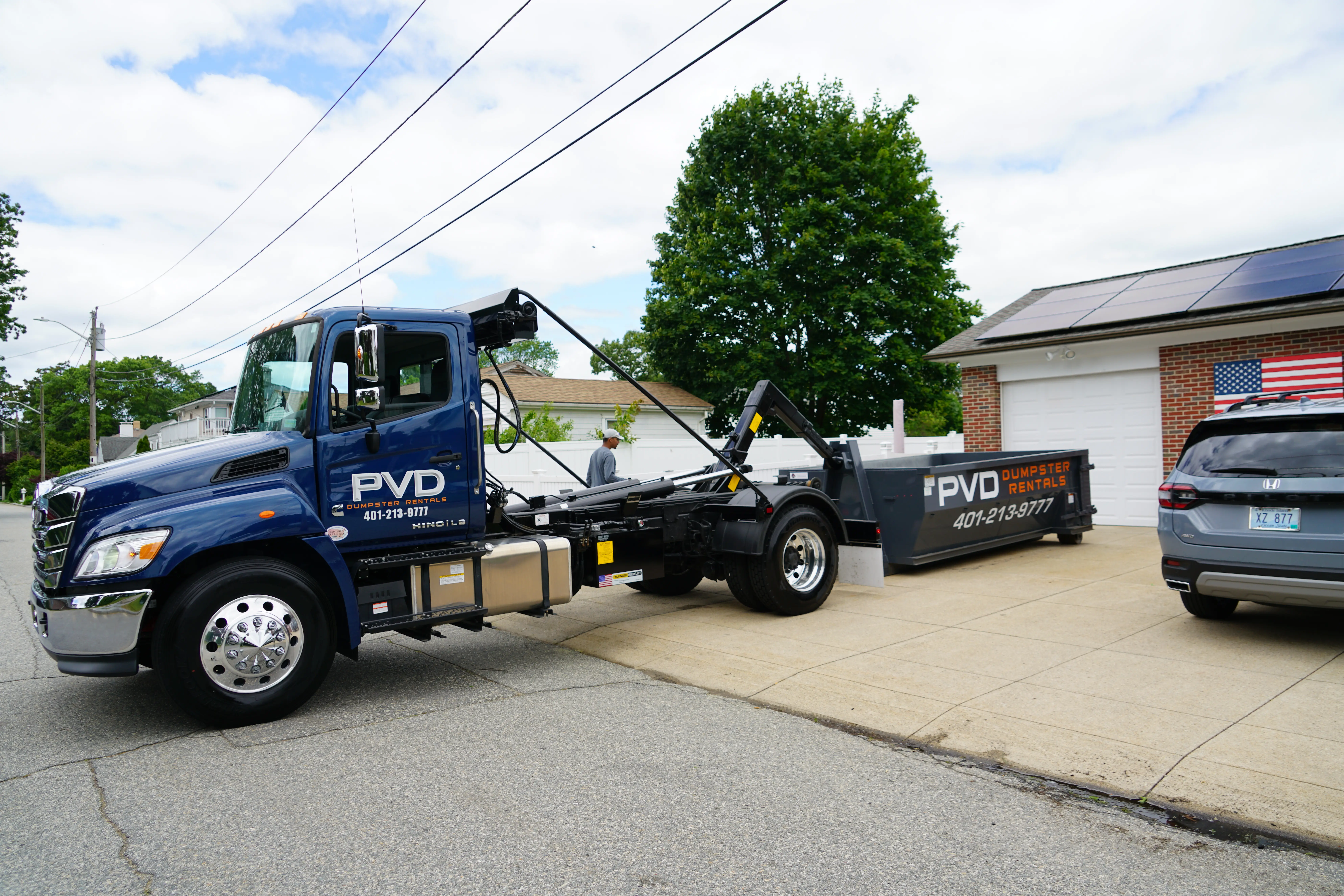 Roll-off dumpster delivered to a residential driveway