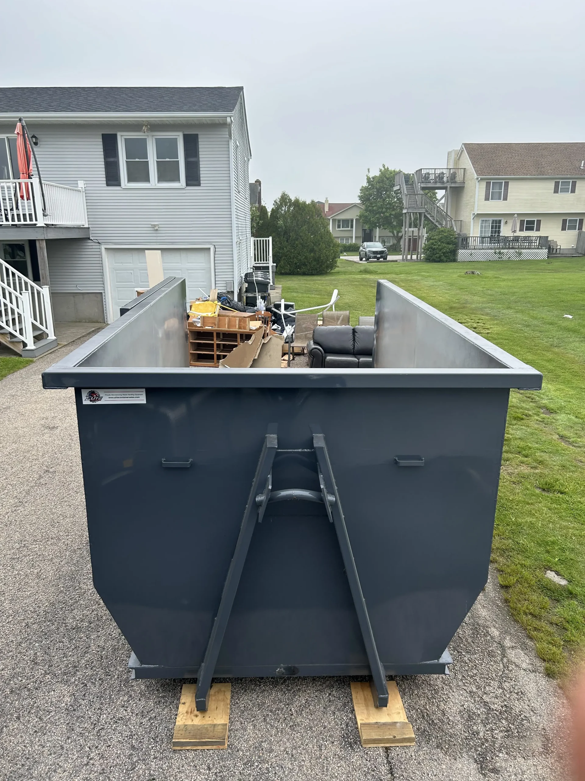 20 yard dumpster loaded with household furniture on a home cleanout job in Cranston