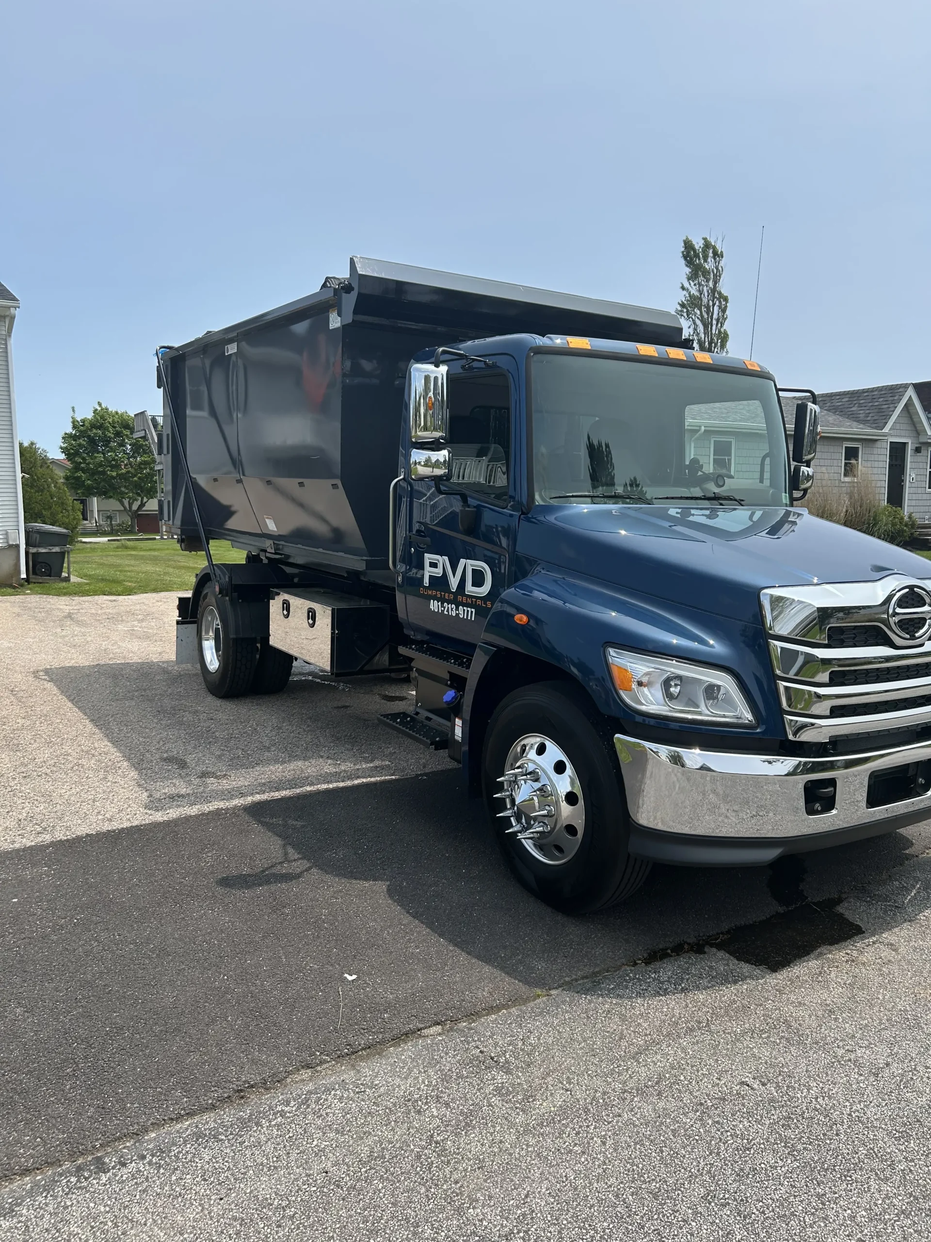 PVD truck arriving to pick up a loaded dumpster